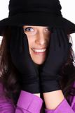 Portrait of a beautiful brunette young woman with gloves and black hat