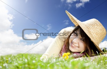 Beautiful brunette girl in hat at meadow.
