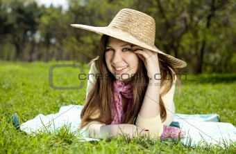 Beautiful brunette girl in hat at the park. 