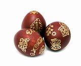 three nice gold decorated Easter eggs closeup over white