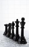 Row of black chess pieces