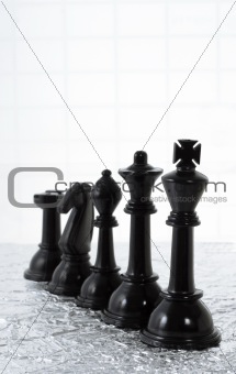 Row of black chess pieces
