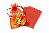 Gold ingots and coins in decorative sachet and red packets