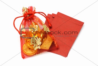 Gold ingots and coins in decorative sachet and red packets