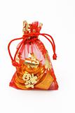 Chinese new year gold ingots and coins in red decorative sachet 