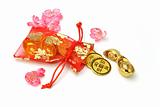 Gold ingots and coins in red sachet 