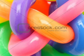 Macro image of interlocked multicolor rubber rings