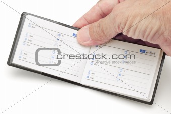 Hand holding mini address book