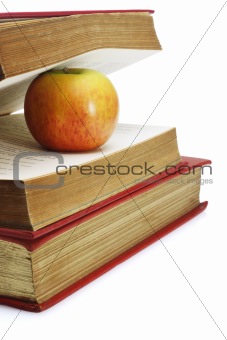 Red apple in between pages of old book