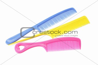 Three plastic combs with handles