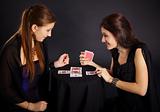Two girls friends engaged in fortune-telling cards