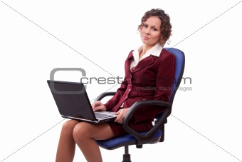 Business woman sitting on chair with laptop