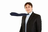Cheerful young businessman with blowing necktie
