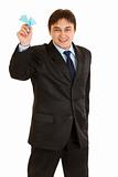 Cheerful modern businessman holding paper airplane in hand
