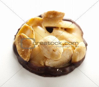 An almond cookie with chocolate on a  white background