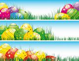 Easter banners with colorful Easter eggs in the young grass.
