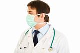 Medical doctor in mask  looking at copy space
