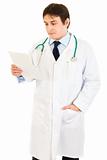 Concentrated medical doctor reading document
