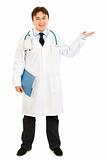Full length portrait of doctor holding medical chart and presenting something on hand

