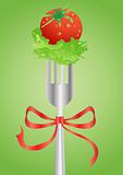 Fresh red tomato and salad on a fork with red ribbon