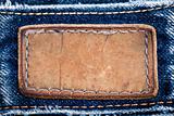 Blank leather jeans label sewed on a blue jeans 