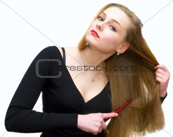 young girl combs hair