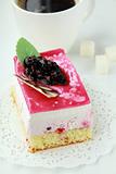 A piece of cake with black currant