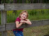 Young Girl Leaning on Fence