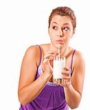 Beautiful young woman drinking a healthy glass of milk - on white background with space for text
