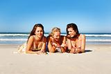 Three young woman having fun on the beach on a summer day