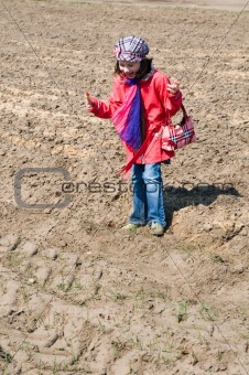 Cute child girl with ice cream playing in the field