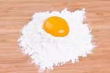 Yolk of egg of house hens and wheat flour on a kitchen board