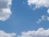 White Puffy Clouds in a Blue Sky With Copy Space