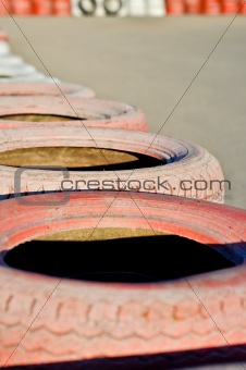 close up of racetrack fence of  red  old tires