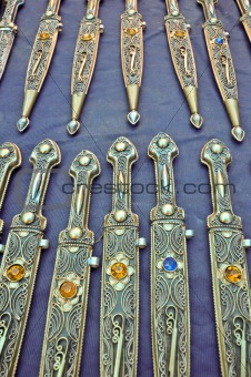 Original antique daggers on a blue cloth