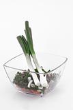 Serrated stone leek and carrot in glass bowl