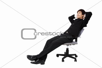 Portrait of a relaxed young businessman sitting on the chair and isolated on white