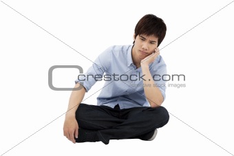 upset young man sitting on the floor