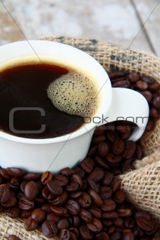 cup of black coffee and coffee beans