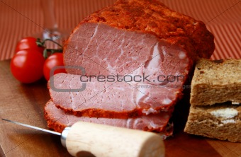 large piece of ham in pepper with a glass of red wine