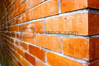 Close-up details of a orange-brown brick wall.