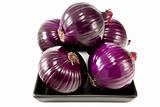 Bunch of red onions on a black plate