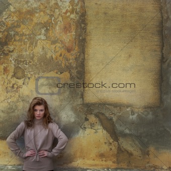 Young girl near yellow wall