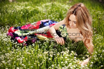 Girl in grass and wildflowers