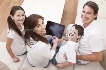 Happy Family Having Fun Using Tablet Computer At Home