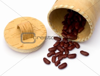 Kidney beans spilling out over a white background