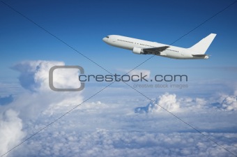 Airliner climbing above the clouds