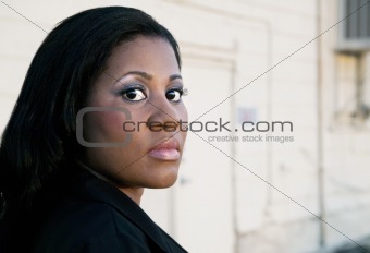 African American Business Woman by Industrial Building