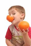 The boy on a white background with oranges
