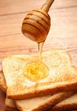 Honey pouring over toast bread